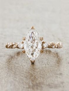 an engagement ring with a pear shaped diamond