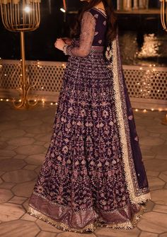 Introducing our New collection 'Chandni Raatein' by Asim Jofa designed to make you look and feel your best. Swathed in the mystique of twilight, this dress is a purple dream woven into existence. Champagne gold zari, like sunbeams kissing a lavender sky, are studded with stardust-like sequins. Threads in mauve and deep purple hues dance in harmony, creating a masterpiece of color. The embroidered dupatta, a wispy cloud of enchantment, finishes this ensemble with the grace of a fairytale ending. Embroidered Front and Back Bodice With Bodice Hem on Net Embroidered Kalis for Peshwas on Net Embroidered Border for Hemline of Peshwas on Net Embroidered Sleeves With Border on Net Embroidered Dupatta on Net With 4 Side Borders Color: There might be slight color variation due to lighting and flashe Purple Churidar With Intricate Embroidery, Festive Long Sleeve Purple Gown, Purple Long Sleeve Festive Gown, Purple Georgette Anarkali Set With Dabka, Unstitched Purple Floor-length Churidar, Purple Zari Work Dress For Reception, Purple Anarkali Gown With Resham Embroidery, Floor-length Purple Churidar, Purple Embroidered Gown For Eid