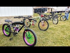 three bikes are parked in the grass near one another