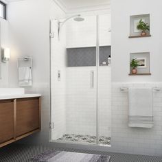 a bathroom with a sink, toilet and shower stall