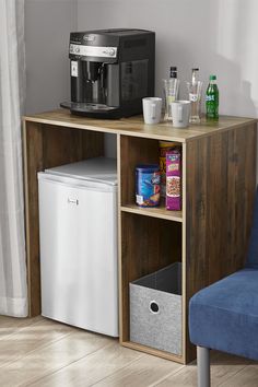 a small kitchenette with a coffee maker and refrigerator