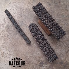 three different types of carving tools on a concrete surface with the words daecour written below them