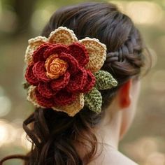 a woman wearing a crocheted flower in her hair