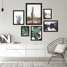 a living room with white furniture and pictures on the wall