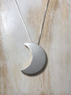 I have made a crescent Moon pendant, inspired by songstress Stevie Nicks! This piece had two sides to which the chain slides through, so you can wear it gold side, or silver side depending on mood and outfit! The entire piece is sterling silver and I 24K gold-plate overlay the other side for a less expensive alternative to solid gold, however, if you want one side to be solid 14K gold, I can do that, too. I've been a fan of Stevie Nicks since I was 6 years old and I began making my version of so Moon Shaped Necklace With Large Pendant, Handmade Celestial Half Moon Necklaces, Handmade Celestial Half Moon Necklace, Symbolic Crescent Moon Phase Necklace, Nickel-free Crescent Celestial Necklace, Unique Crescent Moon Charm Necklace, Sterling Silver Half Moon Phase Necklace, Silver Hand Forged Crescent Necklace, Hand Forged Silver Crescent Necklace