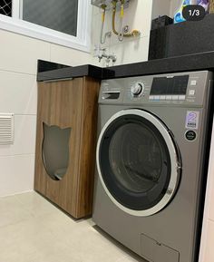 a washer and dryer sitting next to each other in a room with white walls