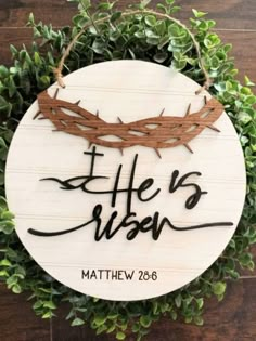 a wooden sign that says, he is risen