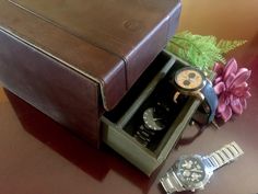 "This dresser top watch case is made of brown genuine leather by Fossil, giving it a sophisticated masculine look with stitched design. It has a top organizer with 6 sectional compartments, each with a cushion to hold the watch. The bottom has a 3-section drawer storage with brass knob to keep other accessories such as cufflinks, tie clips, and jewelry organized. The interior is lined in khaki olive army green canvas fabric. It will be a great wedding gift idea for the groom or groomsmen. Makes Brown Rectangular Watch Accessories For Formal Occasions, Formal Brown Rectangular Watch Accessories, Brown Business Watch Accessories With Case Included, Classic Formal Watch Accessories With Gift Box, Business Brown Watch Accessories Box, Timeless Brown Watch Accessories For Gift, Brown Automatic Watch Accessories For Business, Business Brown Box Watch Accessories, Formal Brown Leather Watch Accessories