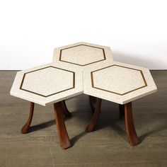 three hexagonal tables sitting on top of a wooden floor