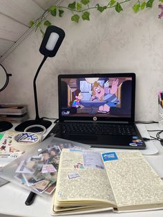 an open laptop computer sitting on top of a desk