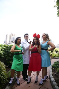 four people dressed in costumes posing for the camera