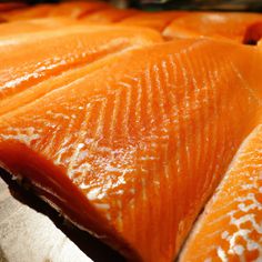 raw fish fillets lined up on a tray