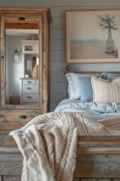 a bed sitting next to a wooden dresser under a mirror on top of a wall