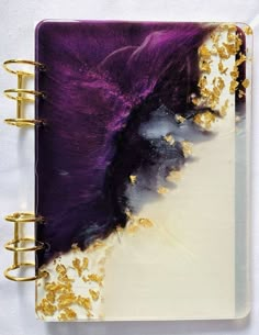 an open notebook with gold and purple designs on it