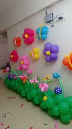 there are balloons and flowers on the wall