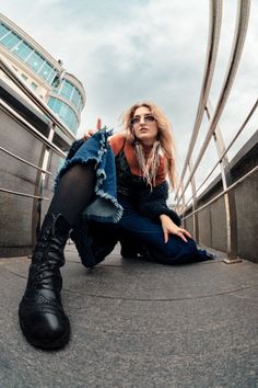 a woman sitting on the ground with her legs crossed