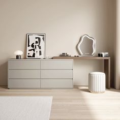 a white dresser sitting next to a window in a room with beige walls and wooden floors