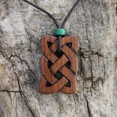 "This hand-carved ancient Irish knot wooden necklace will be hand-carved for you, or a loved one, in my studio on the West of Ireland. Adorned with a lovely green ceramic bead, this intricate Eternity Celtic pendant features a piece of walnut, recycled from musical instruments constructed by a local luthier. As a musician myself, I take enormous satisfaction in creating a necklace whose inherent wood has previously featured in a beautiful hand-made harp. Celtic knots date back to the 3rd to 4th Irish Knot, Ancient Irish, Celtic Pendant, Celtic Knots, Wooden Necklace, Jewelry For Men, Wood Jewelry, Green Ceramics, Ceramic Beads