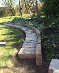 a stone path in the middle of a grassy area