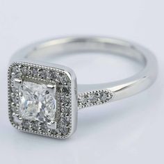 a square cut diamond ring with pave set shoulders