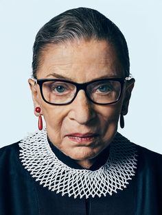 an older woman wearing glasses and a black dress