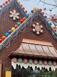 a building decorated with christmas decorations and candy canes on the roof, along with snowflakes