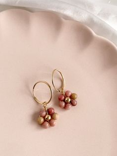 Trendy & nostalgic, yet classic, these gemstone Daisy Hoop Earrings are the prefect piece to spice up any outfit and let your personality shine! Made with 14K Gold Filled 16mm Endless Hoops, Flower centre and wire wrapping and your choice of gemstone. Measures approx 3cm (1.25 inches) from top of hoop to bottom of dangle. Cheap Spring Hoop Earrings, Letter Bead Bracelets, Happy Daisy, Flower Center, Letter Beads, Pouch Bag, Spice Up, Wire Wrapping, Spice Things Up