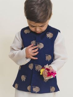 Boys hand embroidered navy blue cotton glaze jacket with white cotton kurta pajama. Color: Navy Blue and White Fabric: Cotton Note: The product will be delivered within 2-4 weeks of order placed Wash Care - Dry clean only No returns and Exchange. Measure before ordering to avoid any returns. Measurements: SIZE CHART FOR GIRLS Age CHEST ROUND WAIST ROUND KURTA LENGTH SLEEVE LENGTH BOTTOM LENGTH CHEST ROUND (ANGRAKHA) DRESS LENGTH (angrakha) LEHENGA BLOUSE LENGTH LEHENGA CHEST LEHENGA LENGTH 1-2 Y Blue Cotton Bandhgala With Zari Work, Festive Cotton Nehru Jacket With Gota Work, Blue Long Sleeve Set With Gota Work, Blue Cotton Bandhgala For Eid, Embroidered Cotton Bandhgala In Blue, Embroidered Blue Cotton Bandhgala, Festive Blue Cotton Bandhgala, Blue Nehru Jacket With Chikankari Embroidery For Festive Occasions, Festive Blue Nehru Jacket With Chikankari Embroidery