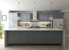 a large kitchen with gray cabinets and white counter tops