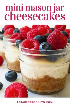 mini mason jar cheesecakes with raspberries and blueberries in the background