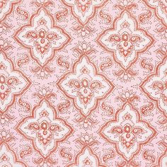 an orange and white paisley print on pink fabric, with small flowers in the center