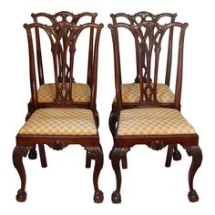 two wooden chairs with beige upholstered seat covers on each one and the other side