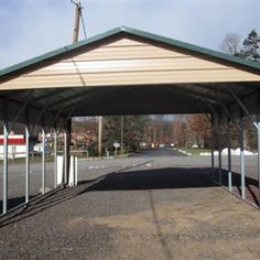 an empty covered parking lot next to a road