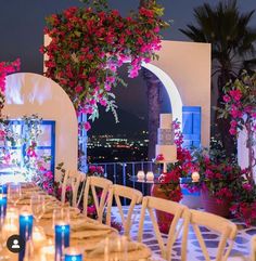 a long table with candles and flowers on it