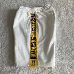 Elevate Your Street Style With These Blank Round "East Meets Street" Boxing Sweatshorts In White. Made Of A Comfortable And Breathable Blend Of Polyester, Cotton Blend Fabric, These Sweatshorts Feature An Elastic Waist And Slash Pockets. Perfect For Casual Occasions Or Travel, These Mid-Rise Sweatshorts Have A Solid Pattern And A Light Fabric Wash. With Accents Like The "Blank Round" Logo And A Regular Fit, These Sweatshorts Are A Great Addition To Any Wardrobe. Available In Size Small, These Sw White Athletic Shorts With Letter Print For Summer, White Athletic Shorts For Streetwear, Sporty White Shorts For Streetwear, White Short Athletic Shorts For Streetwear, White Cotton Athletic Shorts With Letter Print, White Athleisure Shorts With Letter Print, White Letter Print Athleisure Shorts, White Athletic Shorts With Letter Print, Sporty Shorts With Logo Waistband For Streetwear