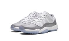 The Air Jordan 11 Low GS “Cement Grey” is the youth sizing of the classic basketball and lifestyle shoe in a go-anywhere colorway.  The Jordan 11 Low “Cement Grey” updates the legacy sneaker with a versatile, mostly white-and-grey color scheme, with a combination of white ballistic mesh and leather on the upper.  A Cement Grey patent leather mudguard contrasts the look.  “Jumpman Jordan” branding appears on the grey nylon overlay on the white mesh tongue.  The white Phylon midsole and icy blue t Jordan 11 Low Cement Grey, Air Jordan 11 Low, Jordan 11 Low, Grey Color Scheme, Cement Gray, Air Jordan 11, Kids Jordans, Icy Blue, Grey Shoes