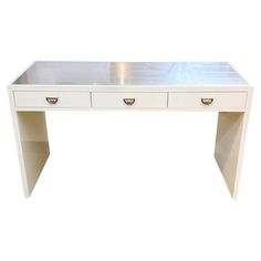 a white desk with two drawers on it's legs and an open drawer at the top