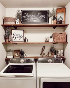 a white washer and dryer sitting next to each other in a laundry room