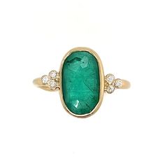 A stunning rosecut Zambian Emerald is set in 14k yellow gold. Accented with Brilliant white diamonds and Emily's seagrass band this is truly a ring that will be forgotten. Approx stone size: 13mm x 9mm Approx ct weight: 2.25cts Mohs hardness: 8 This one of a kind piece is handmade with love in Emily's Hudson Valley studio. It is currently in stock and ready to size and ship. If you have questions about sizing, shipping or need help deciding on a perfect piece please reach out to us! Unjque Emerald Ring, Handmade Bohemian Oval Emerald Ring, Bohemian Style Emerald-colored Ring, Columbian Emerald Ring, Handmade Emerald Ring In Yellow Gold, Fine Jewelry Style, Colombian Emerald Ring, Zambian Emerald, Colombian Emeralds, Local Jewelry