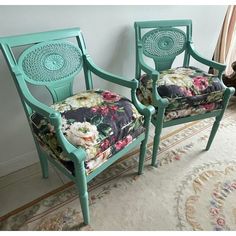 two green chairs with floral upholstered cushions sit in front of a white rug