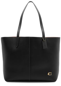 Find COACH Leather Tote on Editorialist. This Coach tote bag features two top handles, a detachable designer tag, a designer plaque, an internal slip pocket, an internal zip-fastening pocket, and is fully lined. It has a magnetic press-stud fastening at the top. The dimensions are as follows: Width: 13 inches/ 33cm, Height: 11 inches/ 28cm, Depth: 6.5 inches/ 16.5cm, Top handle drop: 10 inches/ 25.5cm. Coach Tote Bag, Coach Tote Bags, Coach Tote, Coach Leather, School Bag, Press Studs, Christmas List, 11 Inches, Lana Del Rey