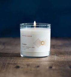 a white candle sitting on top of a wooden table