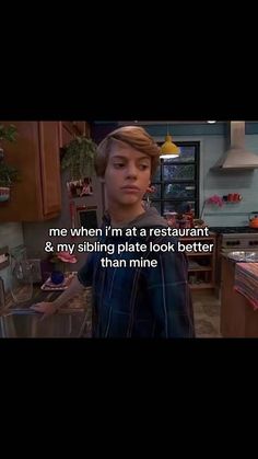 the young man is standing in his kitchen