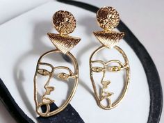 These are unique and abstract   Abstract Metal Face design  Gold color 3 in  These are very lightweight on the ear Easy to wear These Earrings are a classic unique and abstract addition to any wardrobe Trendy Gold Plug Earrings For Gift, Trendy Gold Dangle Clip-on Earrings, Trendy Handmade Gold Earrings, Artistic Metal Earrings With Artistic Design, Artistic Metal Earrings, Artistic Gold Hoop Earrings As Gift, Artistic Gold Hoop Earrings For Gift, Gold Earrings With Artistic Design For Gift, Modern Gold Earrings With Unique Design