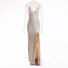 This Ariana Maxi Dress is the perfect choice for a glamorous and chic party look! Featuring a stunning gold sequined design, a flattering v-neckline, and a daring split leg, this dress will turn heads wherever you go. The hollow out back and strappy lace up detailing add a touch of sexiness to this elegant and stretchy dress. Turn your next event into your own personal fashion show with the Ariana Maxi Dress. Material: Polyester V-neck Maxi Dress For Gala Party Season, Glitter V-neck Evening Dress For Gala, Sequin V-neck Dress For Gala, V-neck Sequin Dress For Gala And Party Season, Glamorous Sequin V-neck Dress For Gala, Glamorous V-neck Sequin Dress For Gala, V-neck Evening Dress With Side Slits For Party, Glamorous V-neck Evening Dress With Contrast Sequin, Gold V-neck Evening Dress For Gala