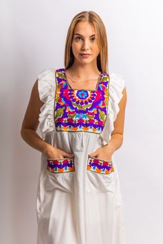 This tunic is a mix of chic, boho, and tribal. The simple consistent embroidery throughout the dress is simple, cute and classy. It is perfect for the summer time. This beautiful bohemian embroidered tunic dress is surely going to add life and oriental charm to your closet. The dress is made of Egyptian cotton which is widely renowned for its quality and texture. The dress is light and extremely soft and can be used on many occasions - beach, lounge, or even in your home to feel comfortable. Fab Bohemian Tunic Dress With Pockets, Peasant Style Embroidered Summer Tunic Top, Multicolor Floral Embroidered Tunic For Summer, Cotton Dresses With Geometric Embroidery For Vacation, Summer Cotton Kaftan With Floral Embroidery, White Embroidered Tunic Top For Summer, Summer Cotton Tunic With Pockets, White Sleeveless Embroidered Dress For Festival, Traditional White Boho Dress