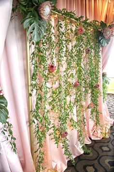 the curtains are covered with greenery and flowers