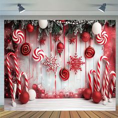 a christmas scene with candy canes and snowflakes hanging from the side of a wall