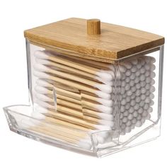 a clear container with matches and wooden sticks in it