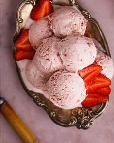 a bowl filled with ice cream and strawberries